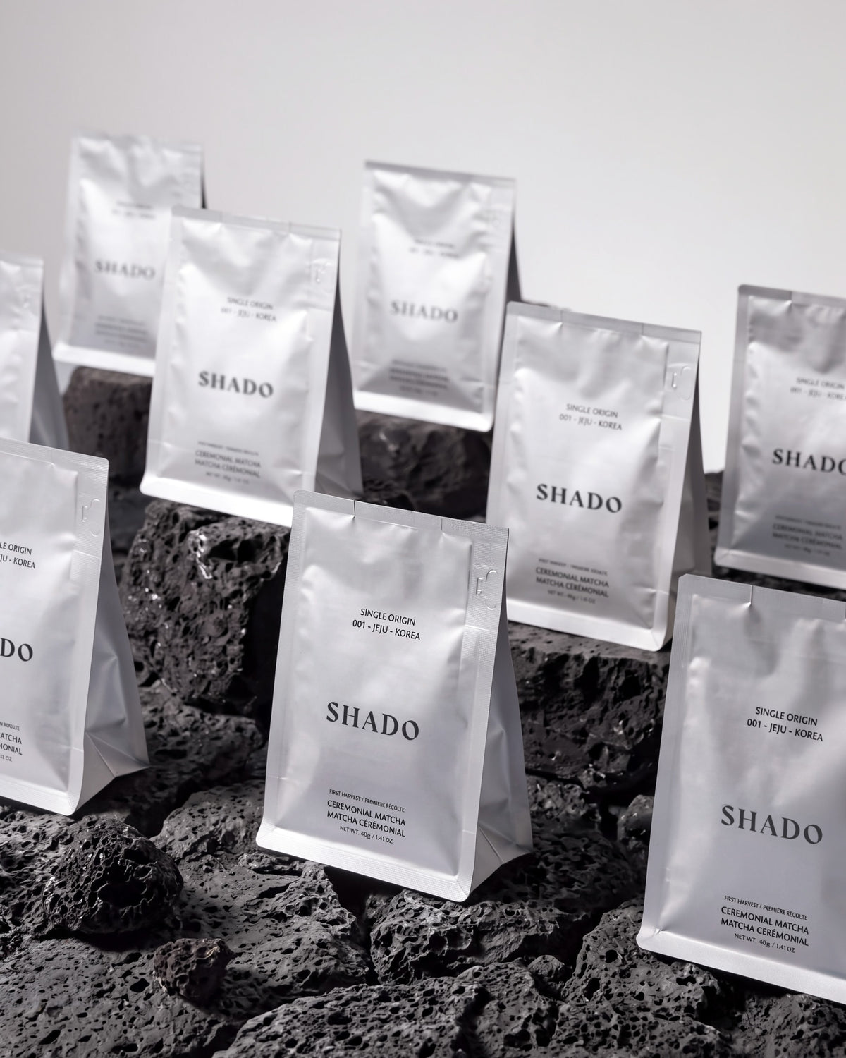 SHADO matcha pouches standing on black volcanic rock